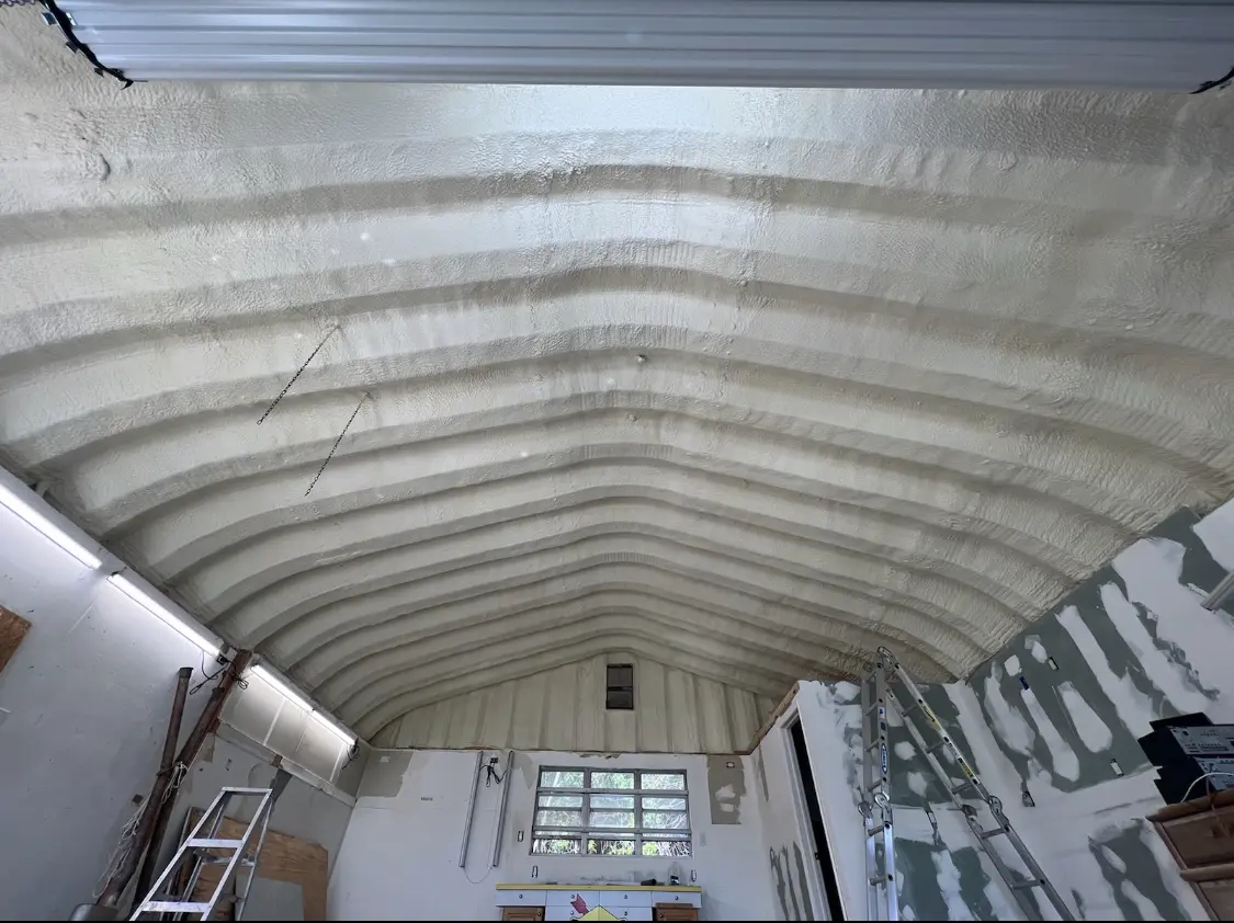 Spray polyurethane foam applied to the underside of a metal roof deck in Lyon